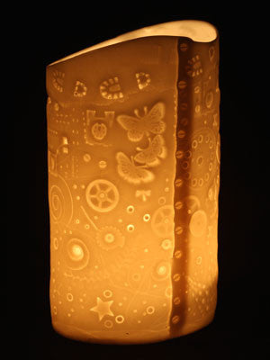 imprinted porclain candle holder depicting the story of Earths history.